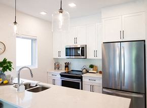 Winnipeg apartment for rent - a kitchen with stainless steel appliances and white cabinets