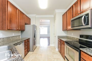 Huntersville house for rent - A kitchen with wooden cabinets and stainless steel appliances.