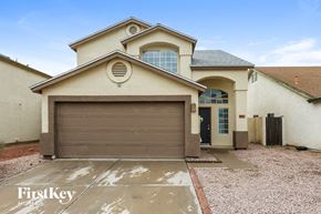 Peoria house for rent - a house with a garage door in front of it