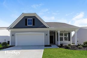 Denver house for rent - a white house with a garage door and a lawn