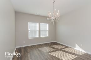Denver house for rent - the living room of a new home with wood floors and a chandelier