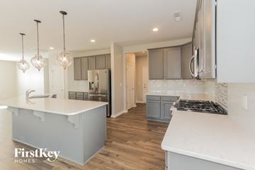 Denver house for rent - a white kitchen with gray cabinets and white counter tops