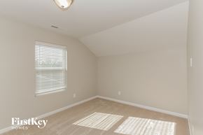 Denver house for rent - a bedroom with a large window and beige carpet and a white ceiling and window