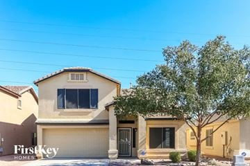 Laveen house for rent - a beige house with a tree in front of it