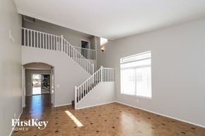 Laveen house for rent - an empty living room with a staircase and a window