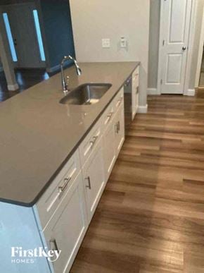 Troutman house for rent - A kitchen with a sink and wooden floors.
