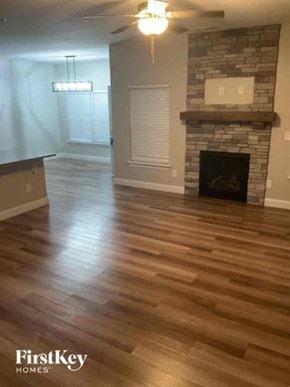 Troutman house for rent - A living room with a fireplace and wood flooring.