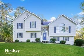 Ball Ground house for rent - a white house with blue shutters and a lawn