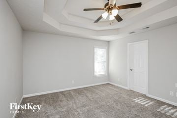 Ball Ground house for rent - the living room has a ceiling fan and a carpet
