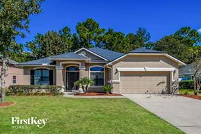 Jacksonville house for rent - A house with a garage and a driveway in front of it.