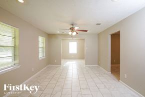 Dickinson house for rent - A spacious room with a ceiling fan and tiled floor.