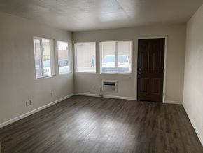 Grandview apartment for rent - an empty living room with wood floors and a door