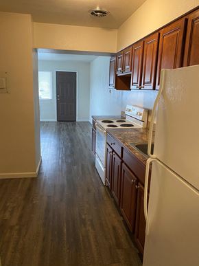 Grandview apartment for rent - a kitchen with white appliances and wood floors