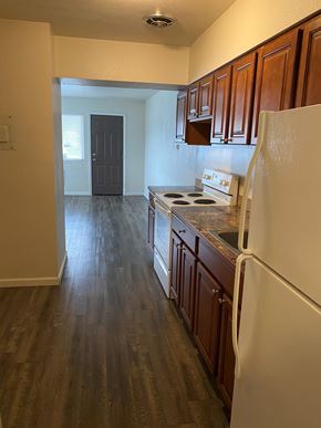 Grandview apartment for rent - A kitchen with wooden cabinets and a white fridge.
