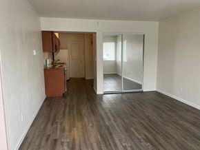 Grandview apartment for rent - A room with wooden flooring and a kitchenette in the corner.
