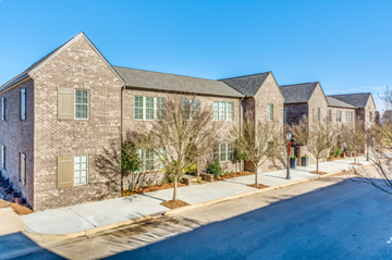 Montgomery apartment for rent - A street view of a residential area with houses and trees.