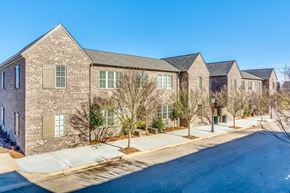 Montgomery apartment for rent - A street view of a residential area with houses and trees.