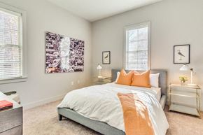 Montgomery apartment for rent - A bedroom with a large bed and a painting on the wall.