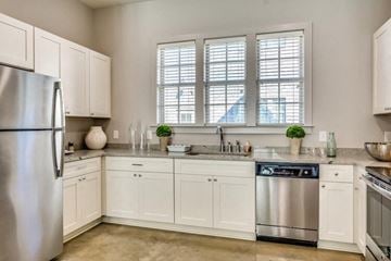 Montgomery apartment for rent - A kitchen with white cabinets and a stainless steel refrigerator.