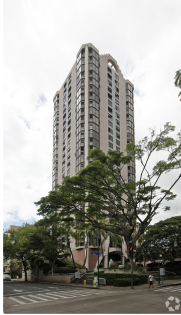 Honolulu apartment for rent - a tall building with a tree in front of it