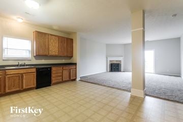 Westfield house for rent - A spacious kitchen with wooden cabinets and a black dishwasher.