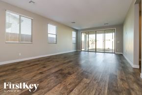 Litchfield Park house for rent - A room with wooden floors and a sliding glass door.