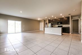 Port Charlotte house for rent - an empty living room and kitchen with a large tiled floor