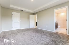 Port Charlotte house for rent - a master bedroom with a carpeted floor and a tiled bathroom