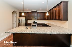Monroe house for rent - an updated kitchen with granite counter tops and dark wood cabinets