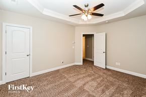 Monroe house for rent - a bedroom with two doors and a ceiling fan