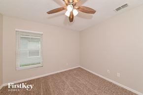 Apollo Beach house for rent - the bedroom has a ceiling fan and beige carpet