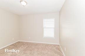 Jacksonville house for rent - a bedroom with a carpeted floor and a window