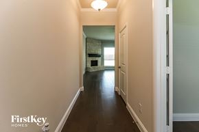 Joshua house for rent - a hallway with a door to a living room and a fireplace