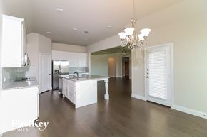 Joshua house for rent - a large kitchen with white cabinets and a white counter top