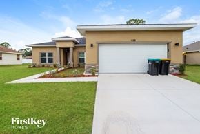 Palm Bay house for rent - A house with a garage and a driveway in front of it.