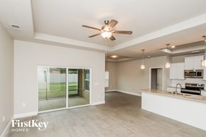 Palm Bay house for rent - A spacious kitchen and living room with a ceiling fan and pendant lights.