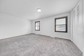 Fridley apartment for rent - an empty living room with white walls and a window