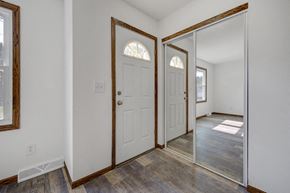St Paul apartment for rent - a bedroom with a white door and a mirror