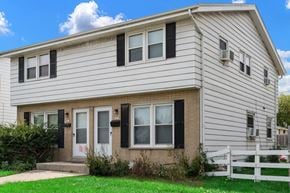 Milwaukee triplex for rent - A house with a white picket fence in front.