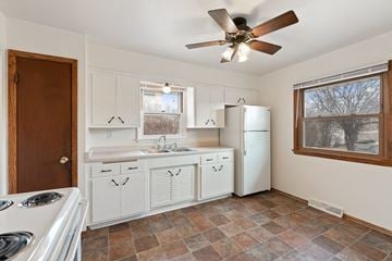 Milwaukee triplex for rent - a kitchen with white appliances and a ceiling fan