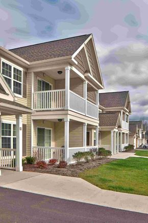 Churchville apartment for rent - a row of homes with a porch and a sidewalk
