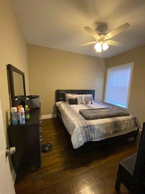 Chicago apartment for rent - a bedroom with a bed and a ceiling fan