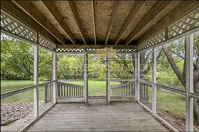Burnsville house for rent - A wooden gazebo with a lattice top and a wooden floor.