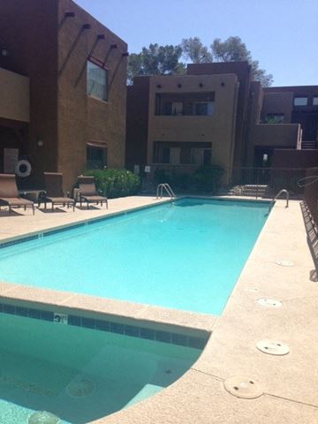 Tucson house for rent - a swimming pool in front of an apartment building