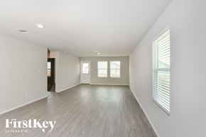 Converse house for rent - A spacious room with wooden flooring and white walls.