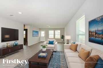Converse house for rent - A living room with a white couch and a blue rug.