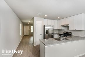 Converse house for rent - A modern kitchen with a stainless steel refrigerator and a sink.