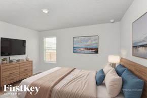 Converse house for rent - A bedroom with a bed, a dresser, and two pictures on the wall.