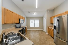 Jacksonville house for rent - a kitchen with stainless steel appliances and wooden cabinets