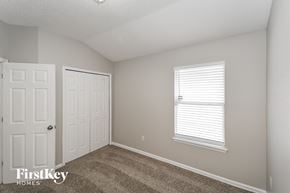 Jacksonville house for rent - a bedroom with two closets and a window and a door